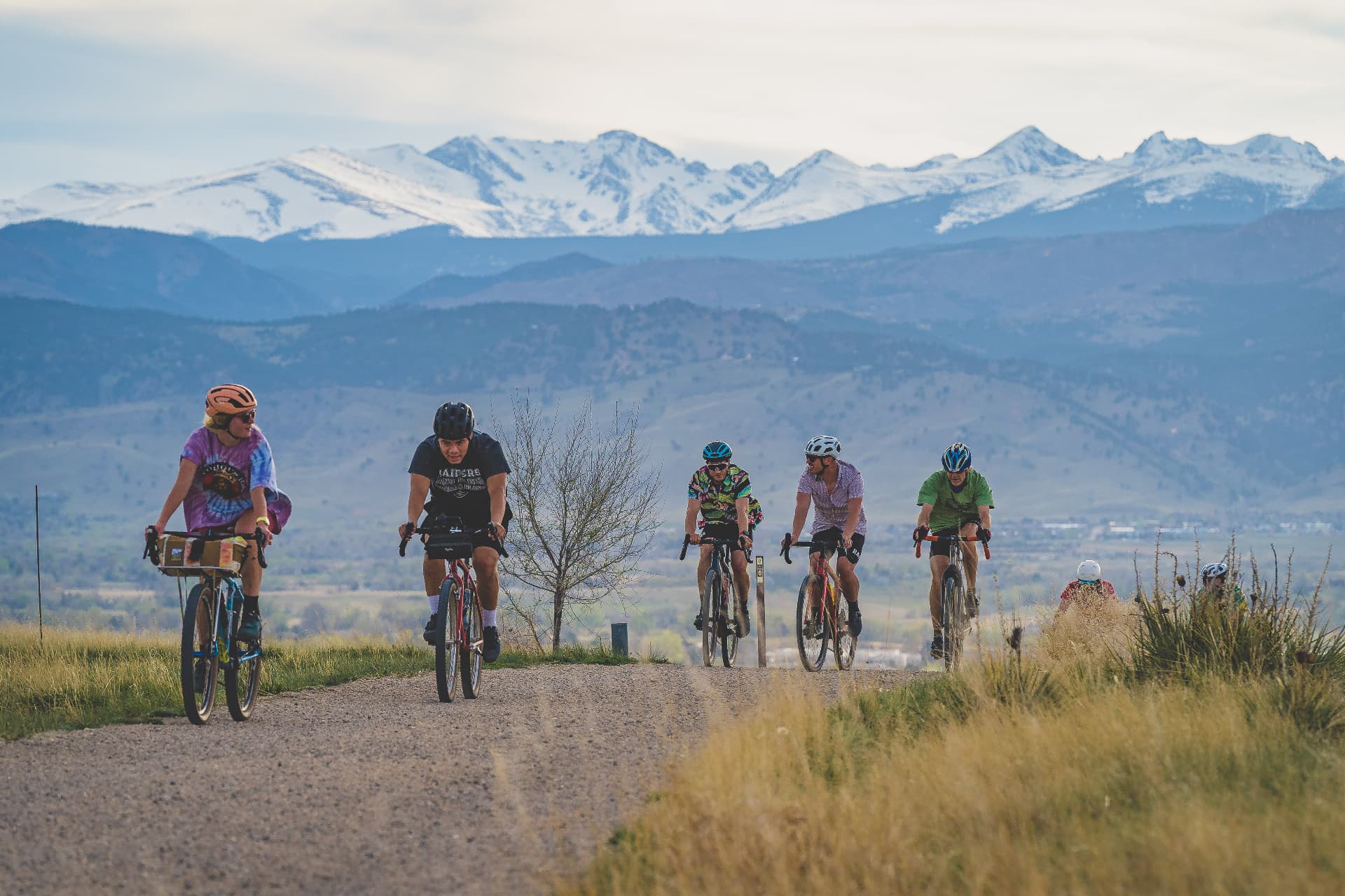 TGIF riders climbing with the mountains behind